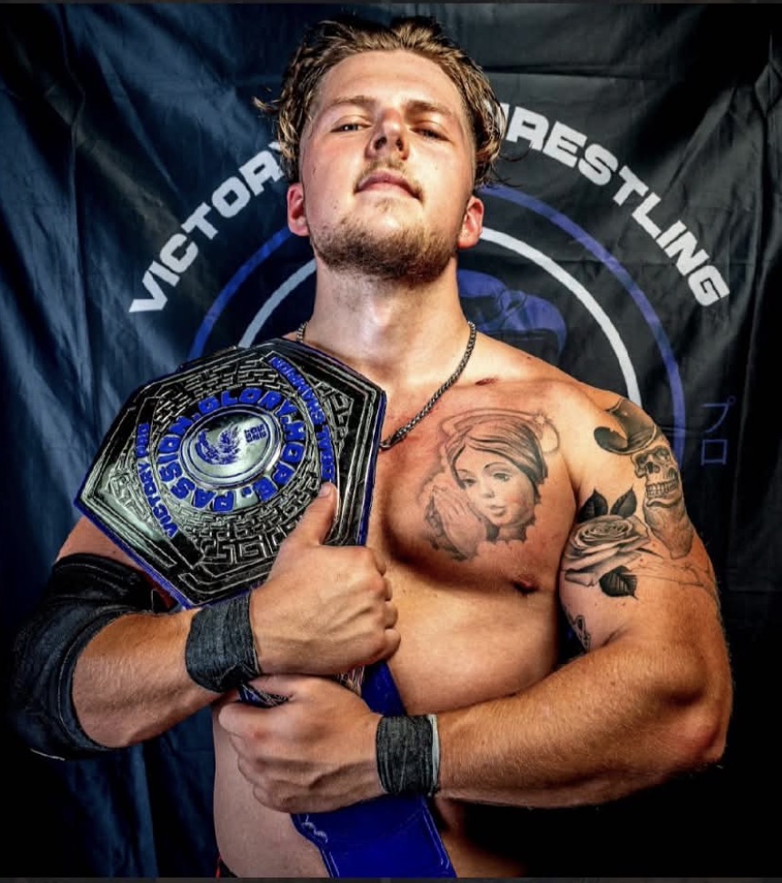 Rey Connor, The Bounty Hunter, holding a championship belt
